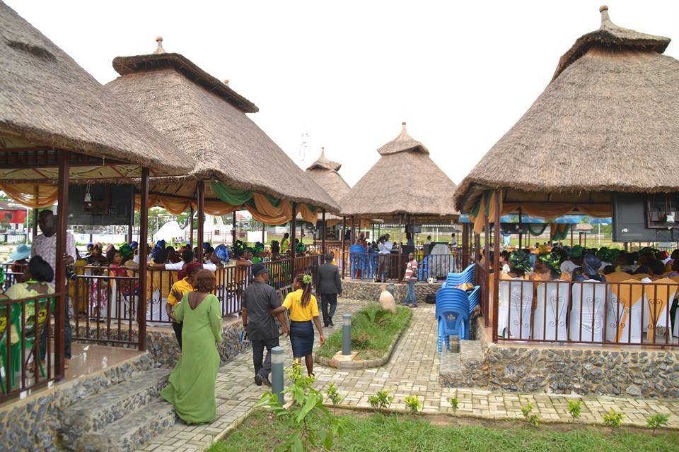 Visitors sitting in and walking around tents in the Calabar Municipal Garden.