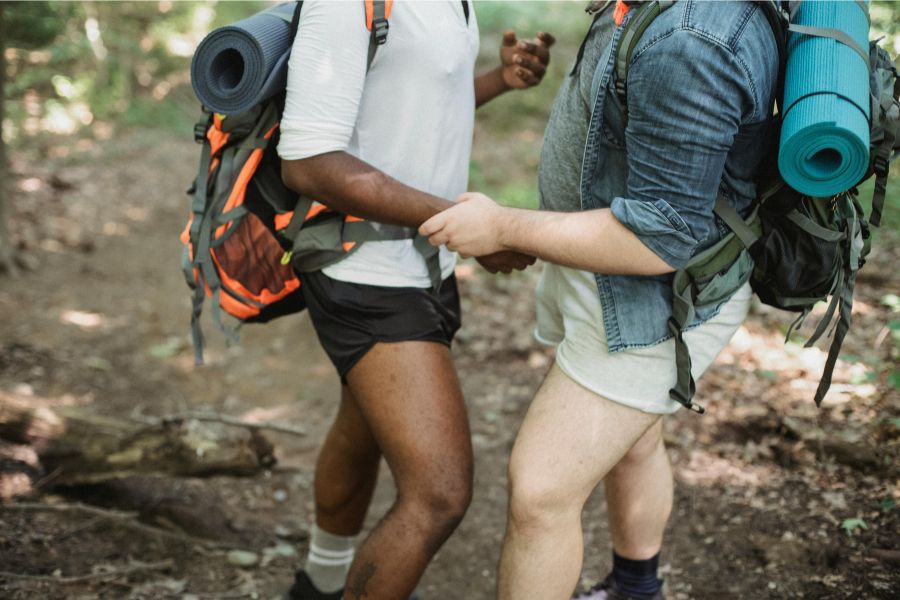 A gay couple trekking in forest
