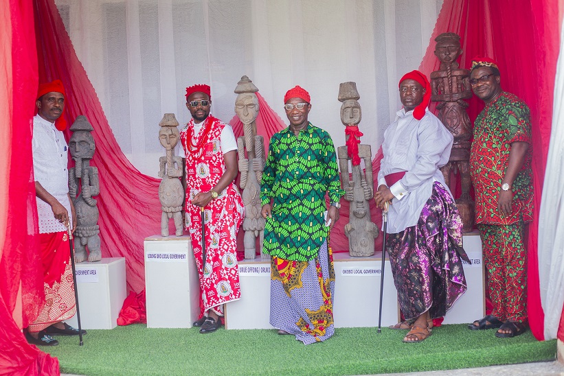 Representatives of each Oron constituency standing next to Ekpu Oro figures at the National Museum Uyo.