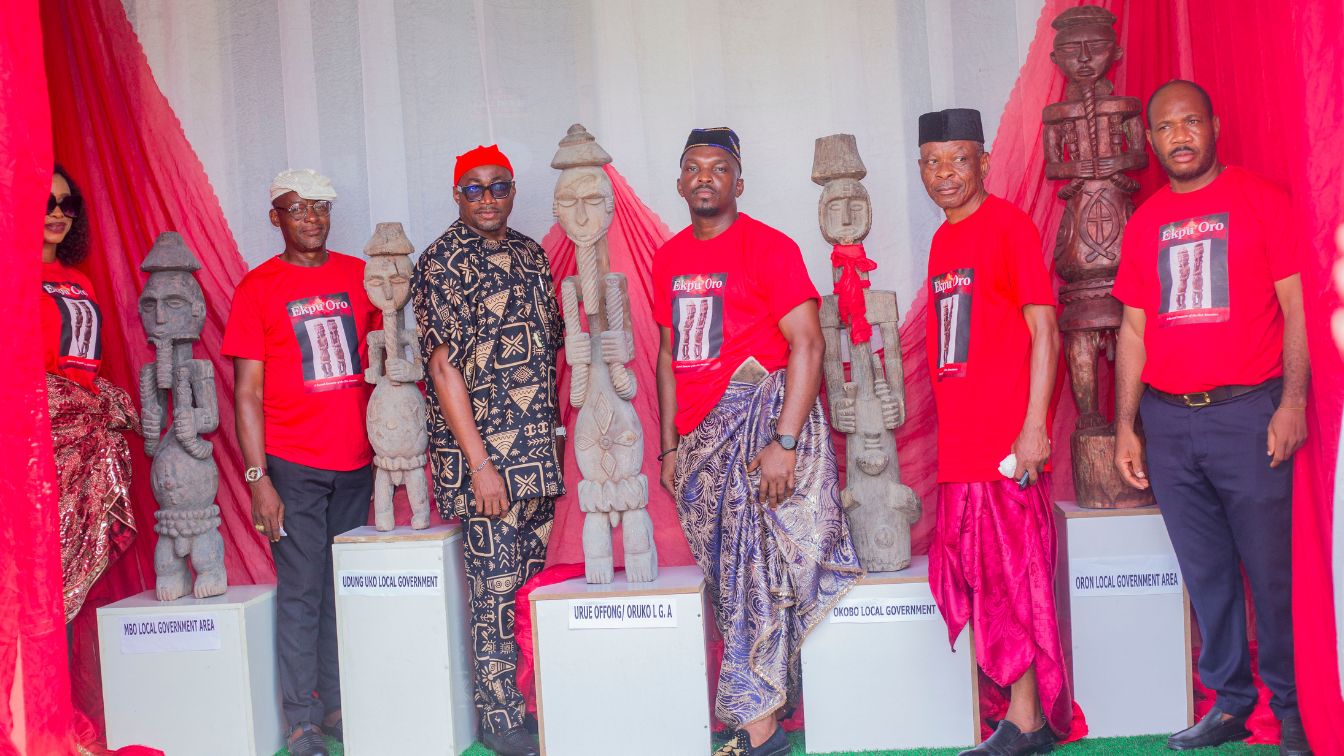 Members of the National Museum Society Uyo standing next to the Ekpu Oro figures during International Museum Day 2026 celebration at the Uyo National Museum.