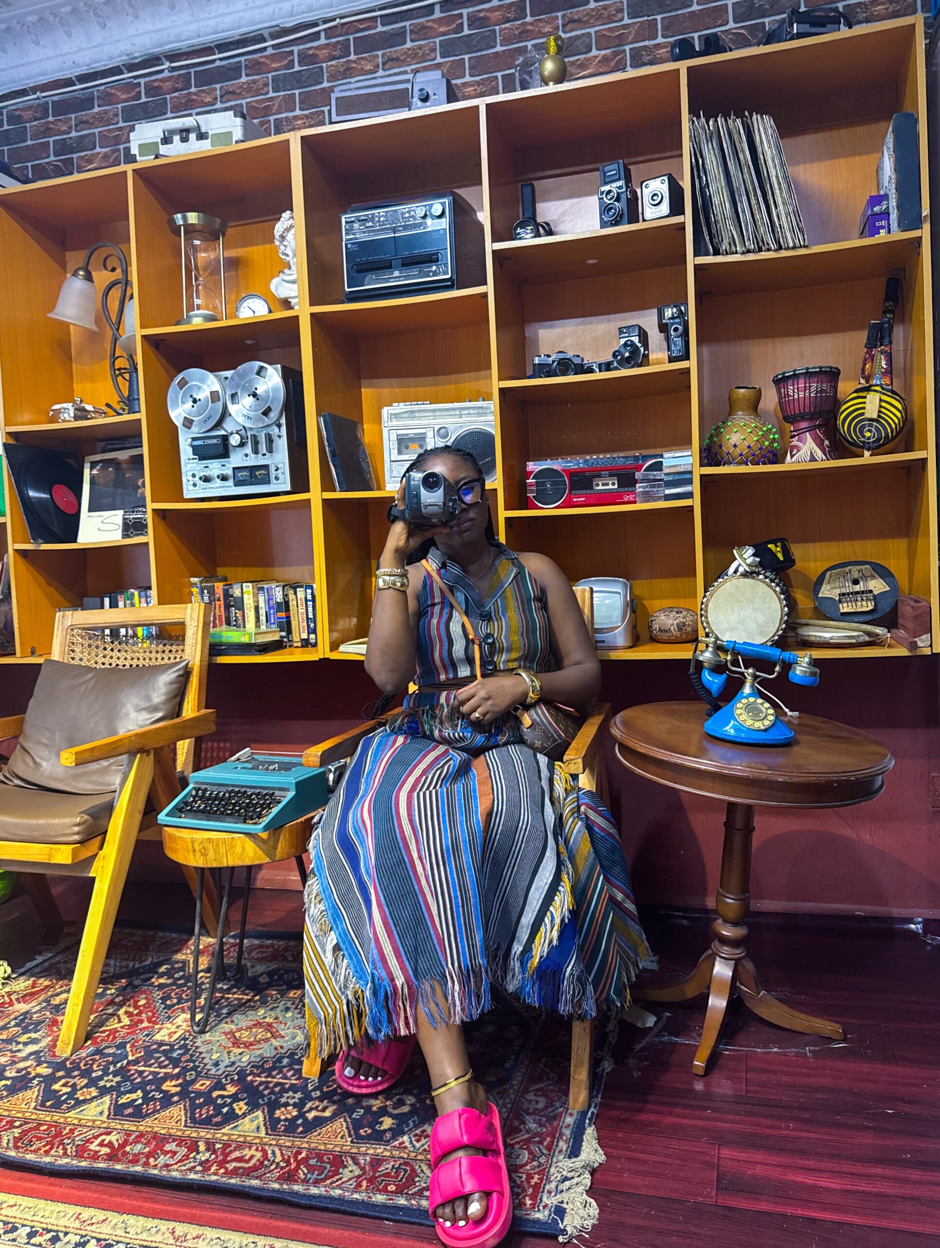 A visitor at the Vintage Africana Museum with a camera