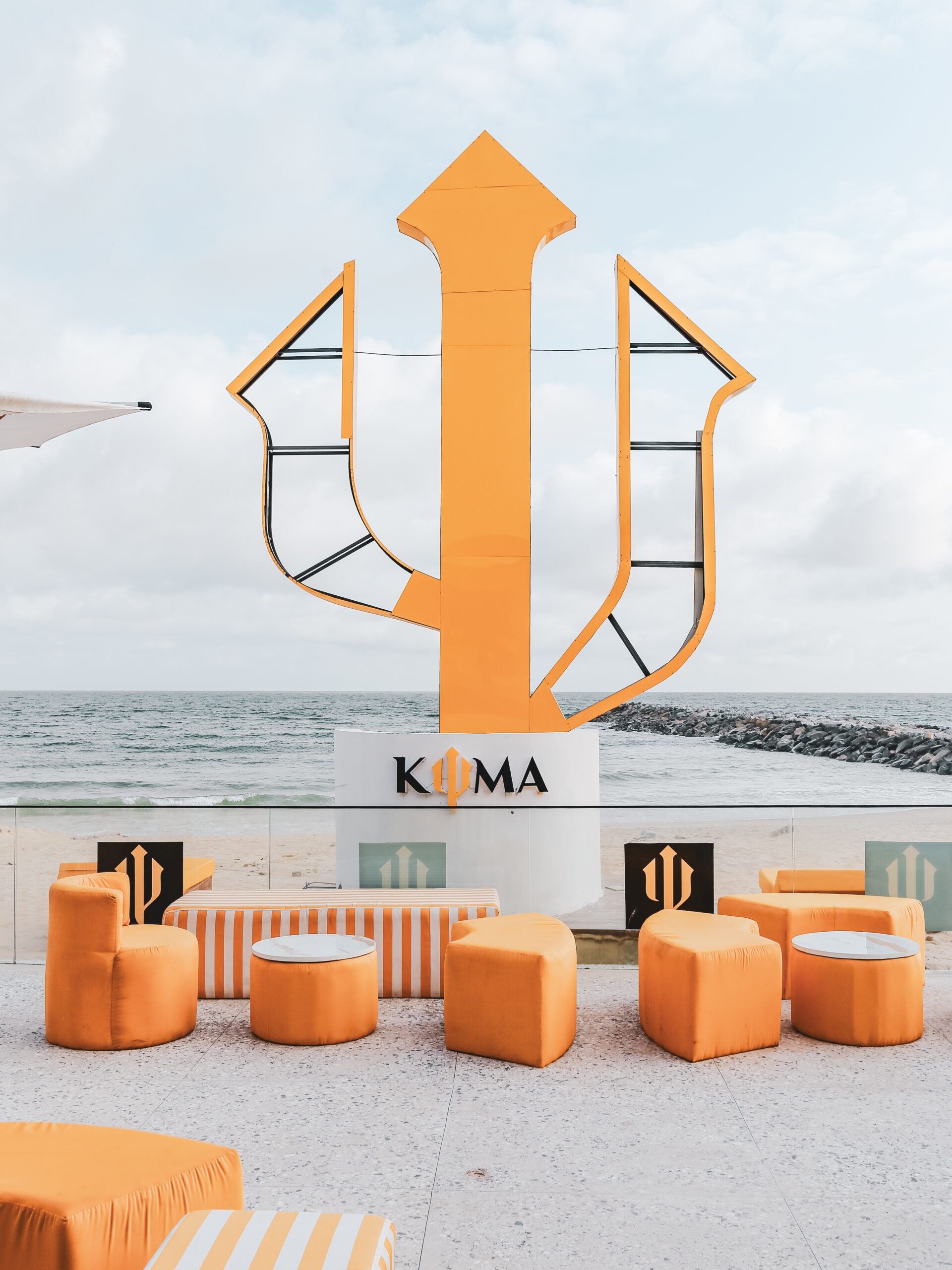 Kyma Beach giant logo and seats by the beach.