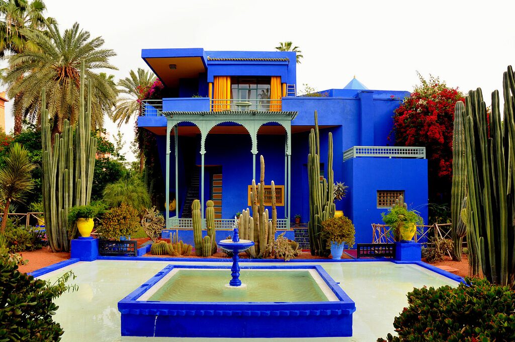 The Majorelle Garden (Jardin Majorelle) with organized plant species and the Majorelle Blue brightening the building walls.